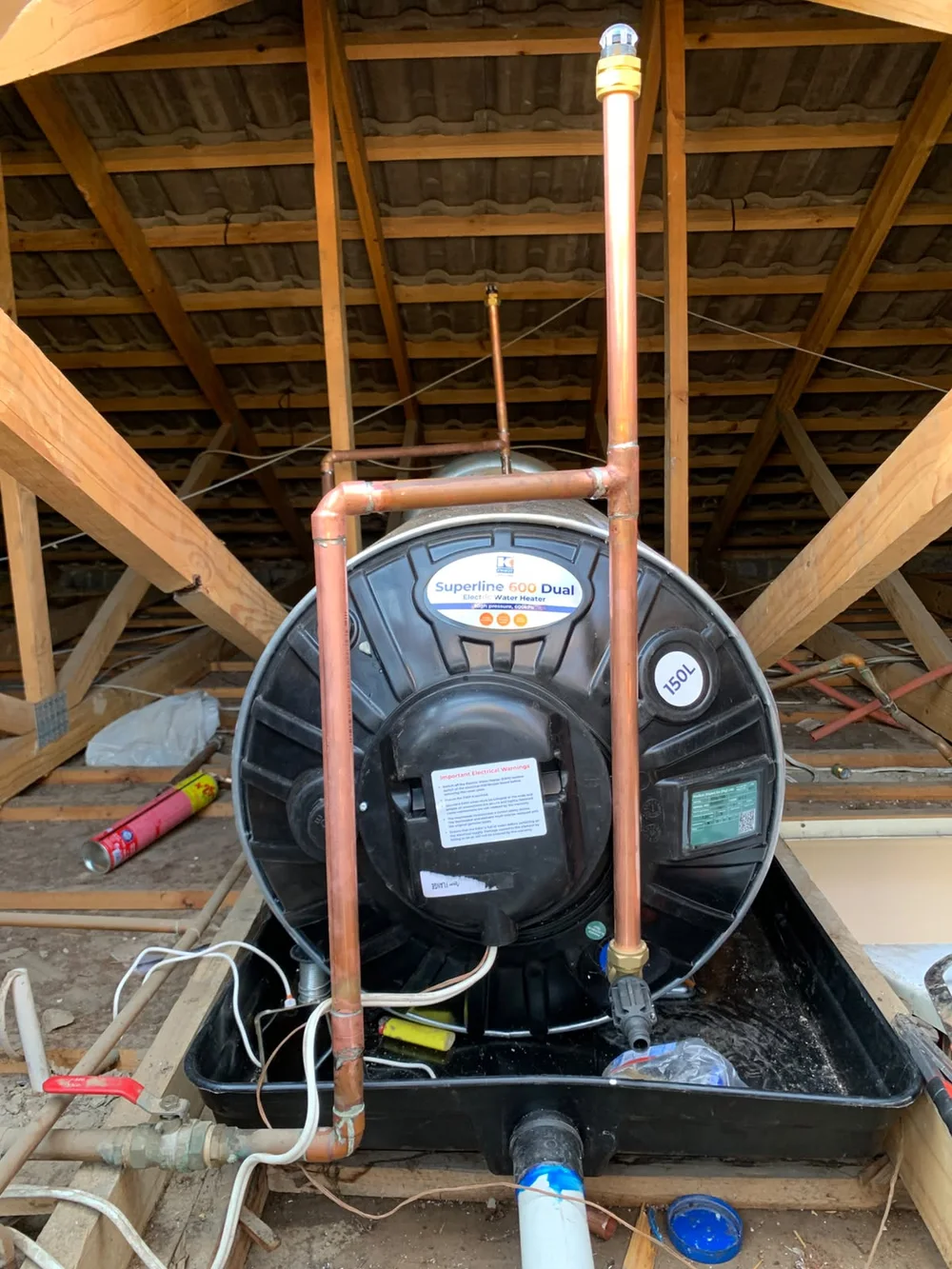 Electric geyser installation with copper pipework in a roof space