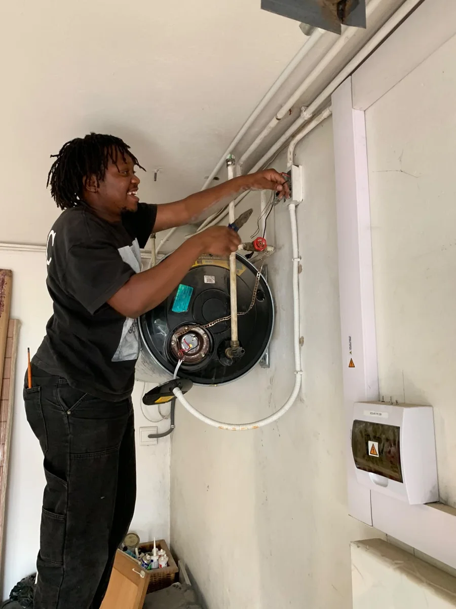 Muzee working beside an electric geyser